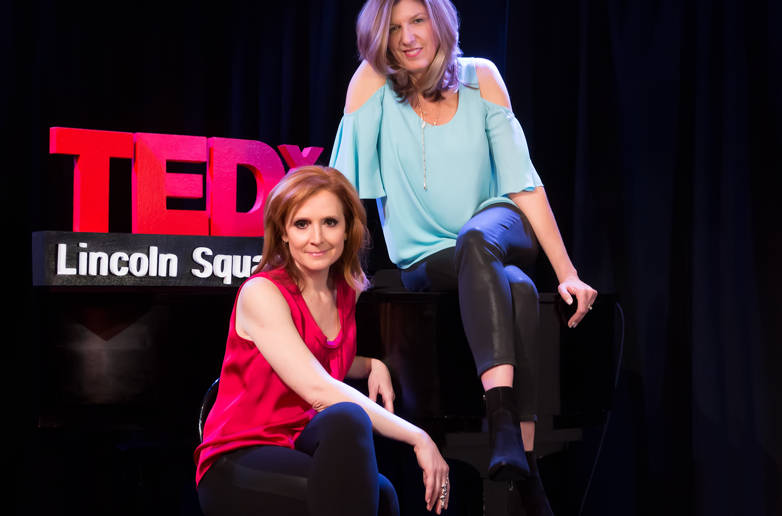 Tricia Brouk the executive producer and creative director of TEDx Lincoln Square sitting on the TEDx Lincoln Square stage with co-producer Jamie Broderick