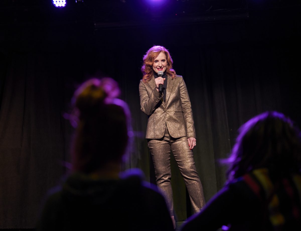 Tricia Brouk in front of an audience, on stage