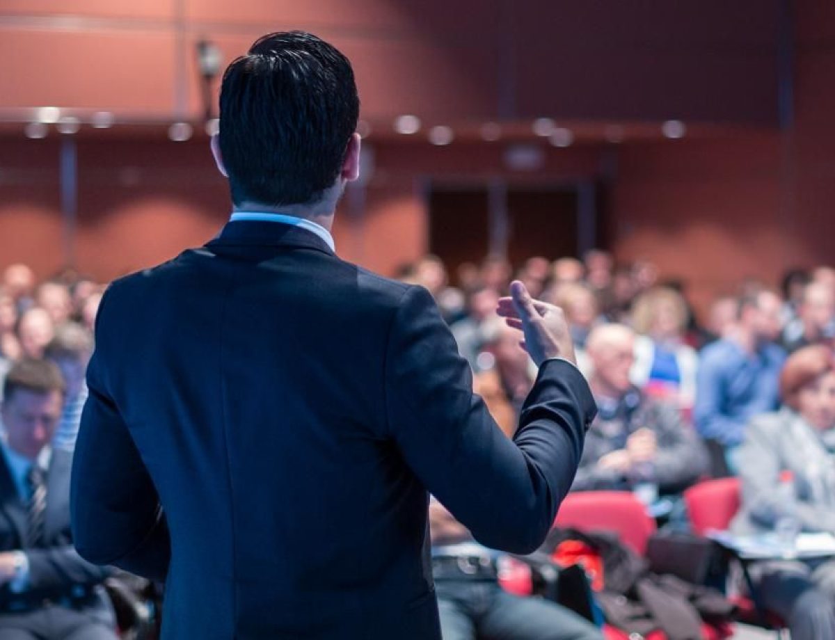 Speaker at a TEDx event addressing the audience